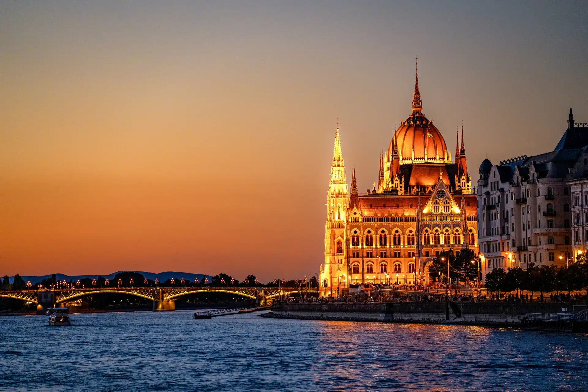Budapest Danube river cruise at night with the illuminated Hungarian Parliament building in the background