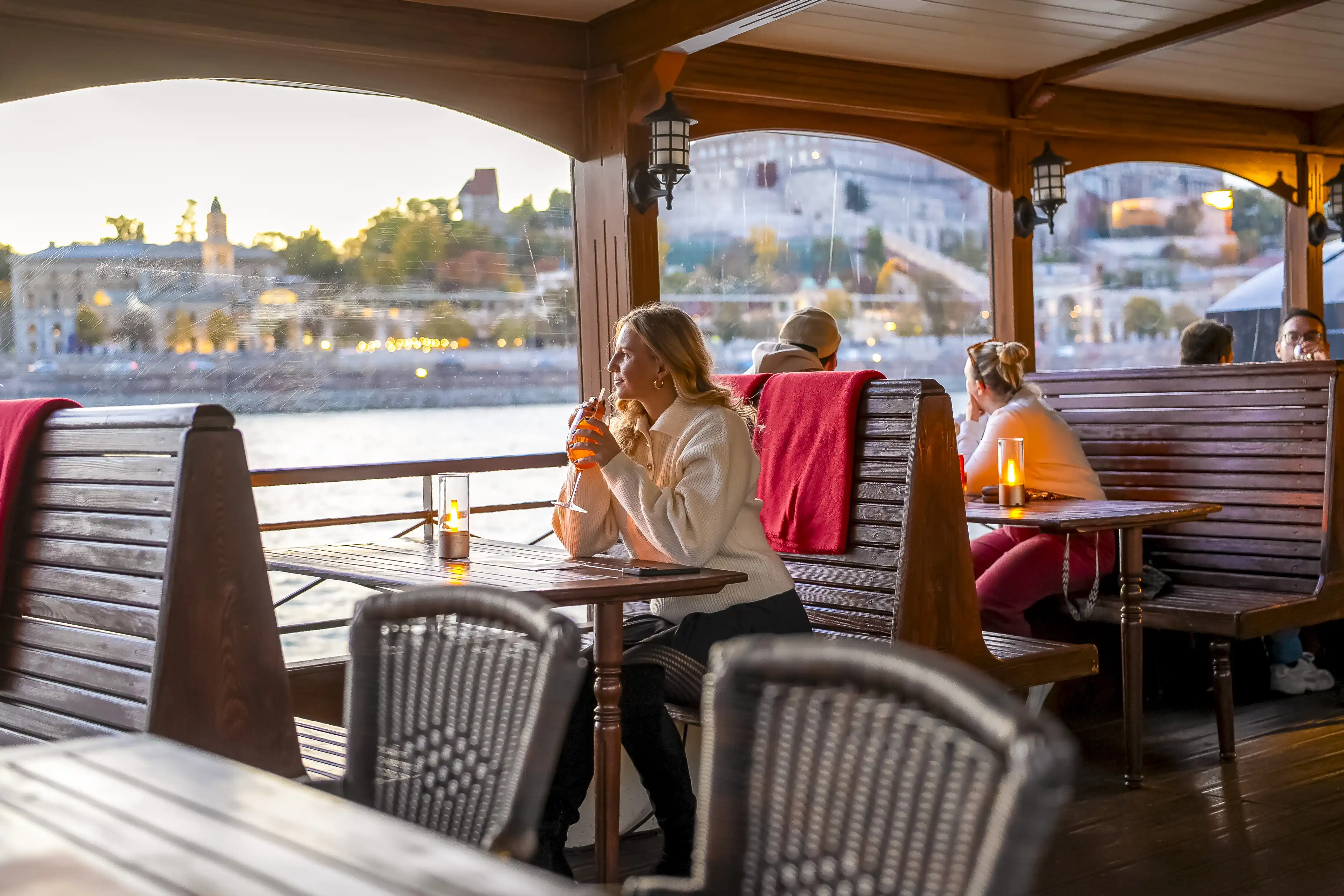 Heated boat tour Budapest featuring panoramic winter views of the illuminated city landmarks