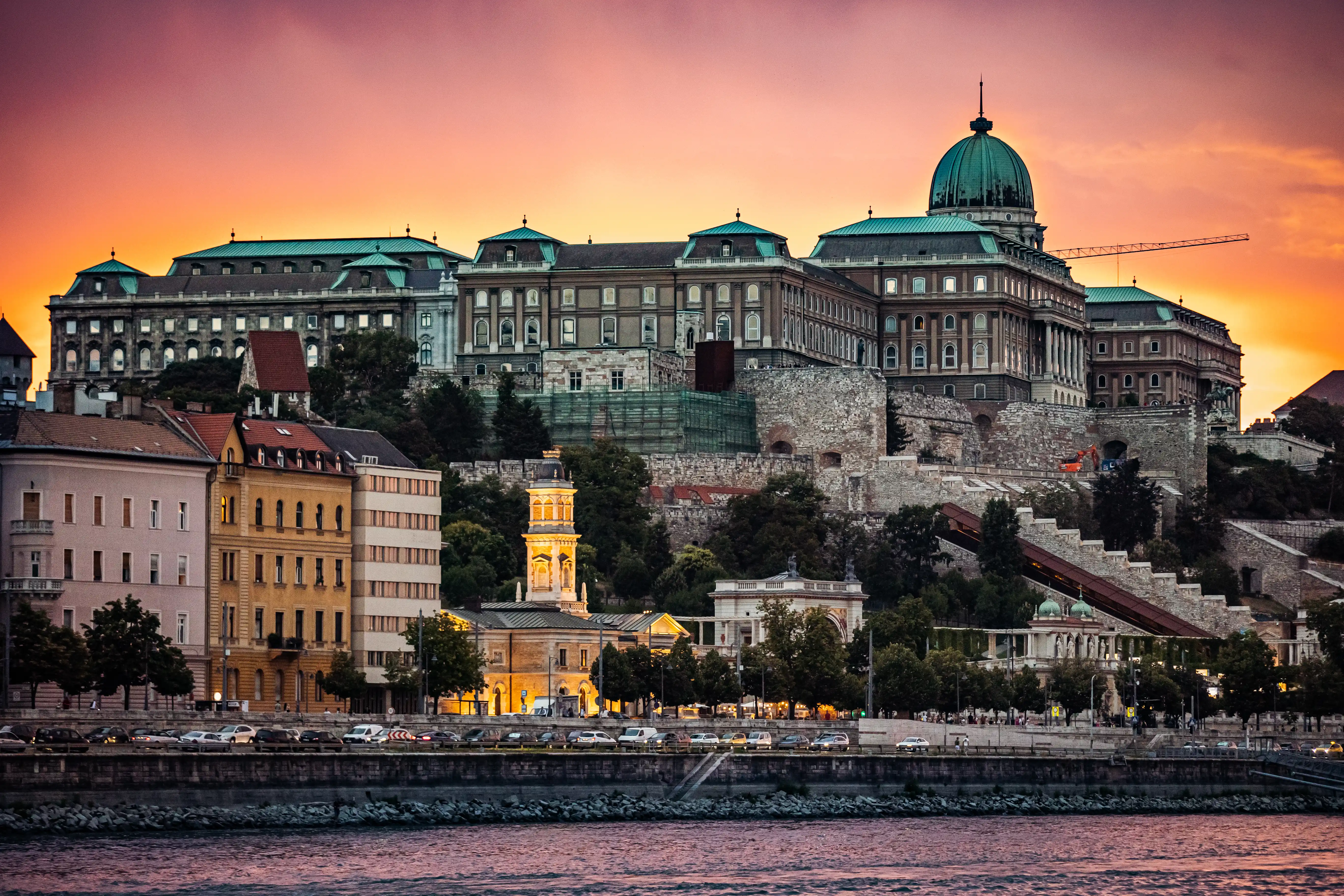 Buda Castle and Fishermans Bastion skyline during sunset from a Danube river cruise