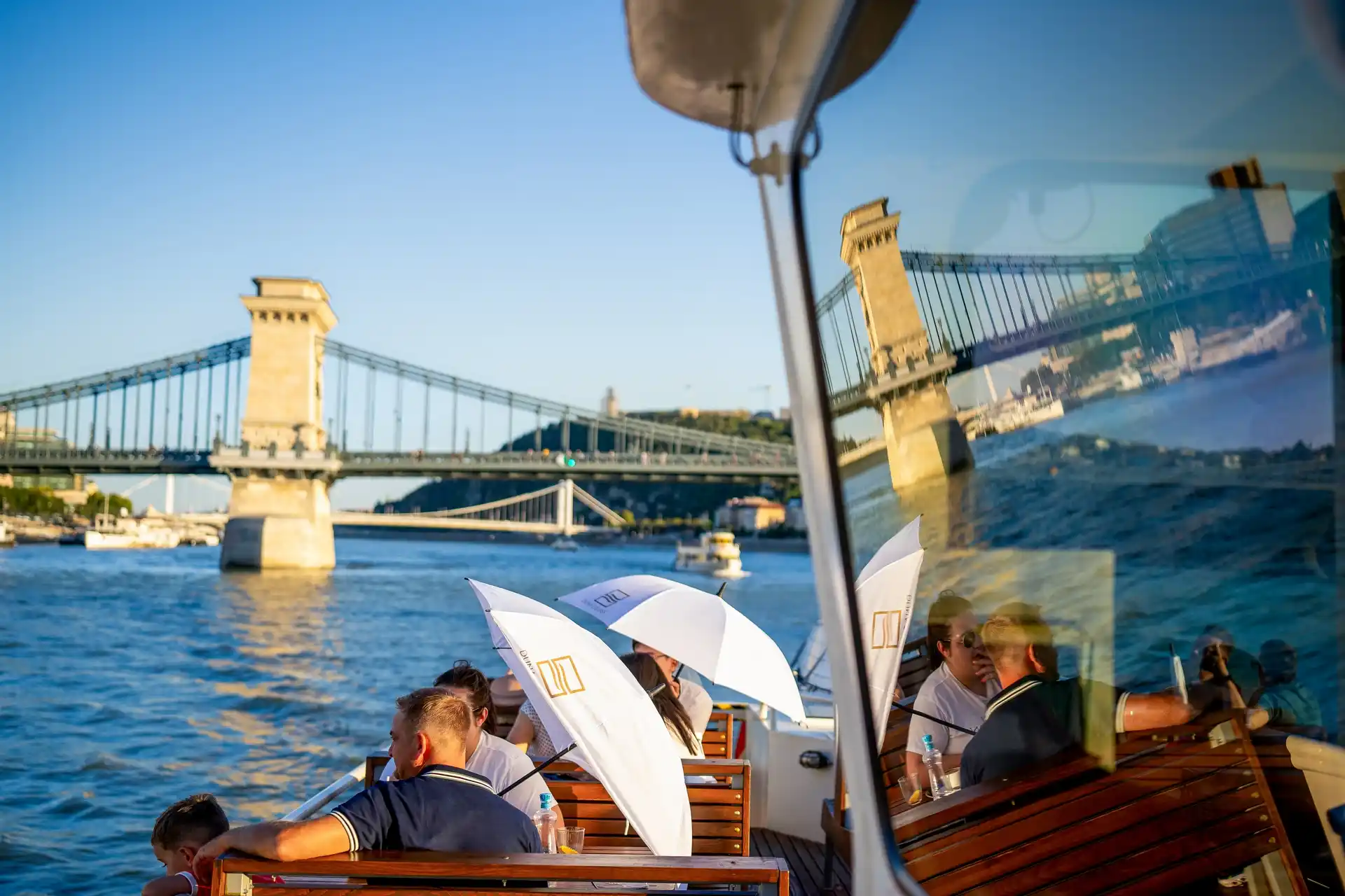 Travelers enjoying a relaxing and chill sightseeing experience on a Budapest boat tour