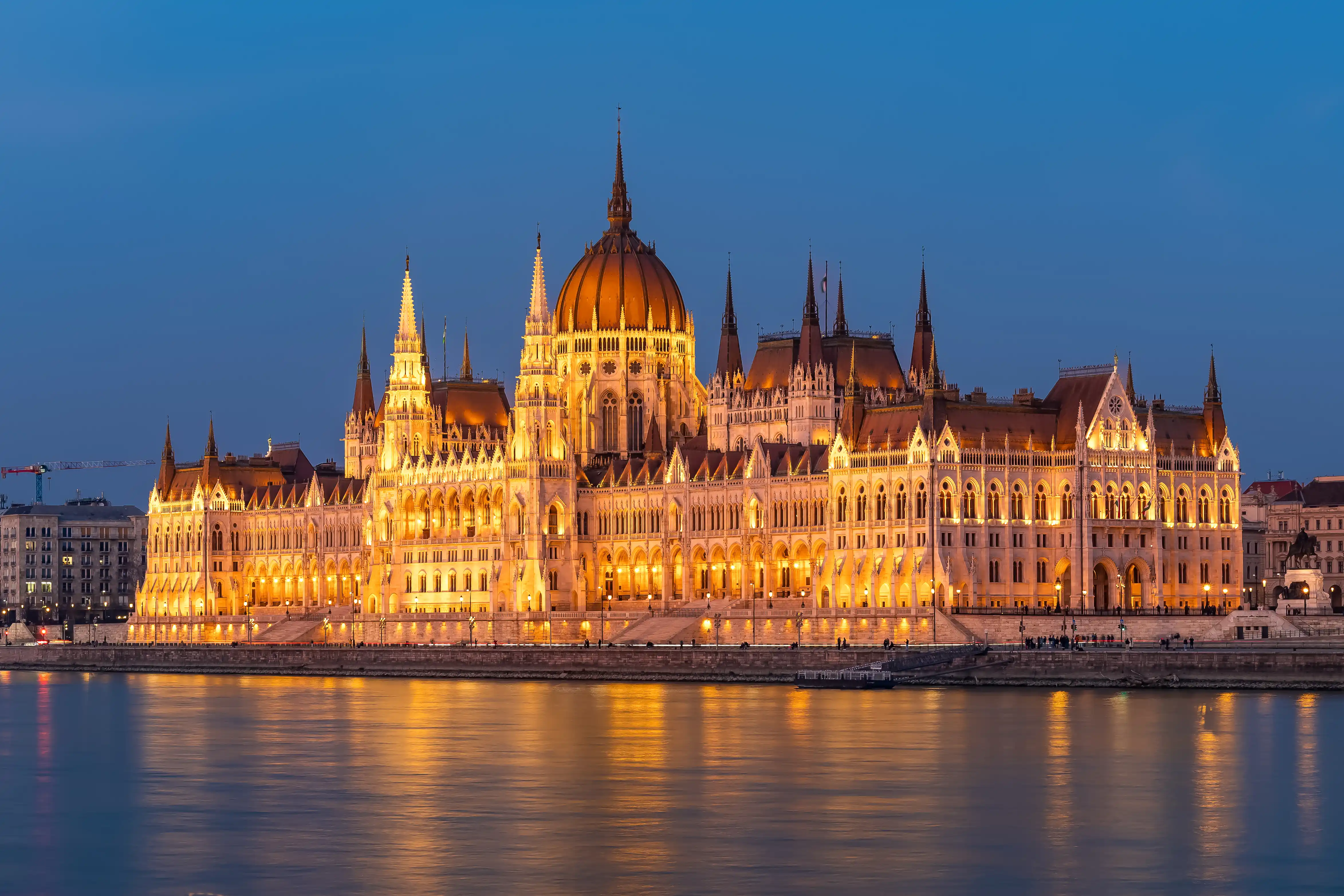 Evening cruise Budapest experience featuring the fully illuminated Hungarian Parliament building at night